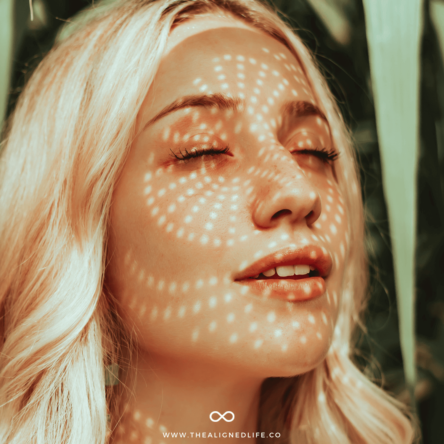 blonde girl with her eyes closed | Secrets of The Law of Abundance | The Aligned Life Manifestation Blog