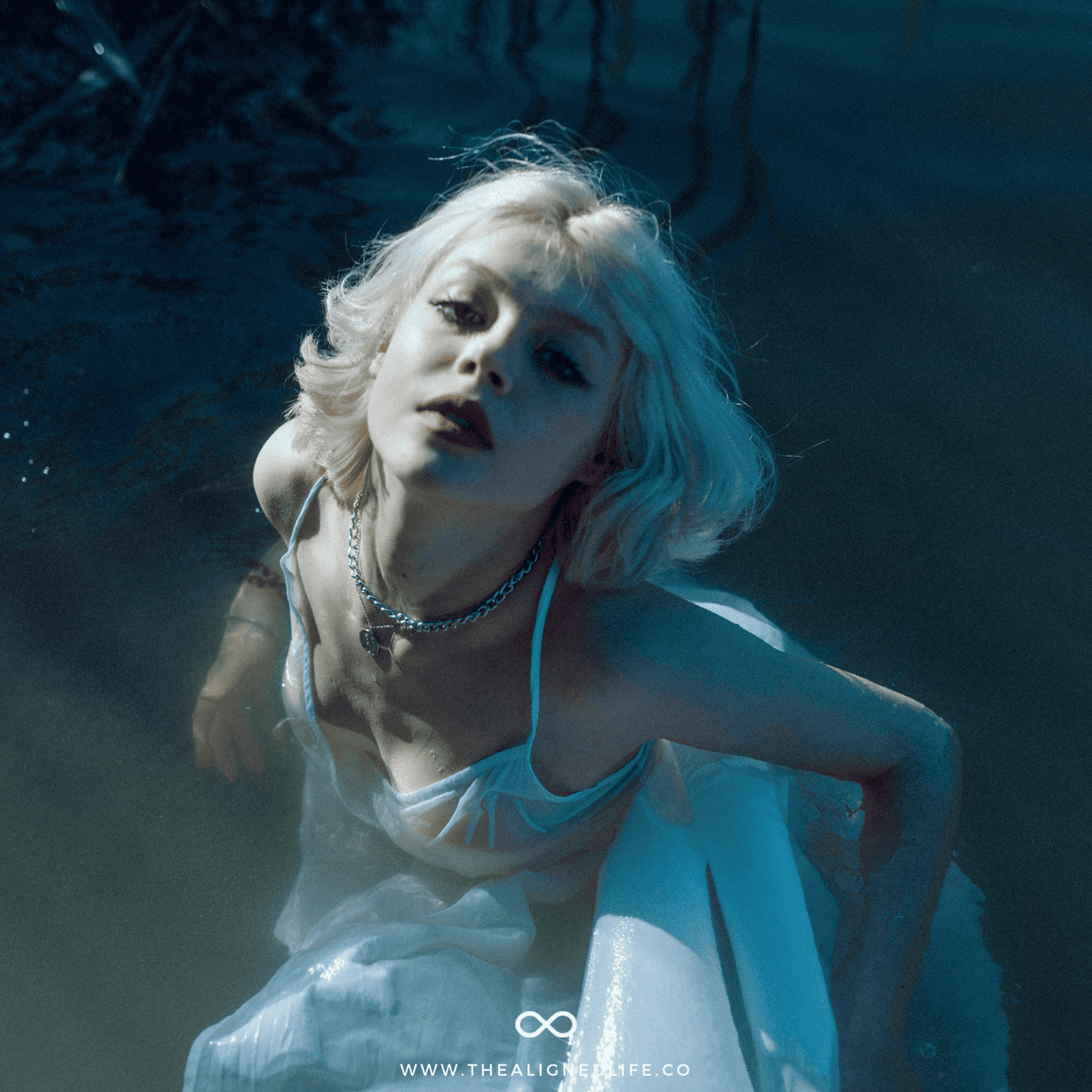 blonde woman in white dress in water | Shadow Work For Your Astrological Sign | The Aligned Life Manifestation Blog