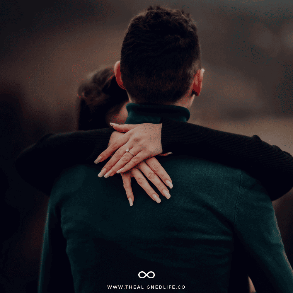 woman with engagement ring with her hands around a man's neck | 11 Spiritual Signs Your Ex Is Thinking About You | The Aligned Life