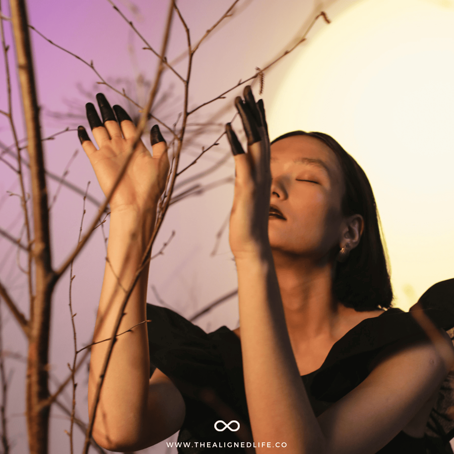 woman with black painted fingers by a tree | A Simple Guide To Planetary Magic | The Aligned Life Manifestation + Spirituality Blog