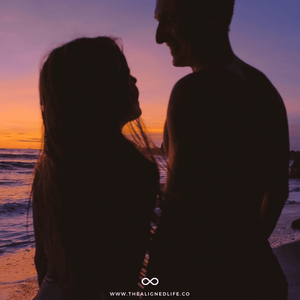 woman and man on a beach during sunset | How To Manifest Love | The Aligned Life Manifestation Blog
