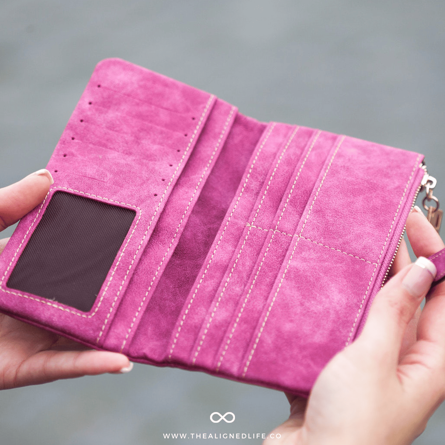 woman holding an empty pink wallet | Understand The Energy Of Money | The Aligned Life Manifestation Blog