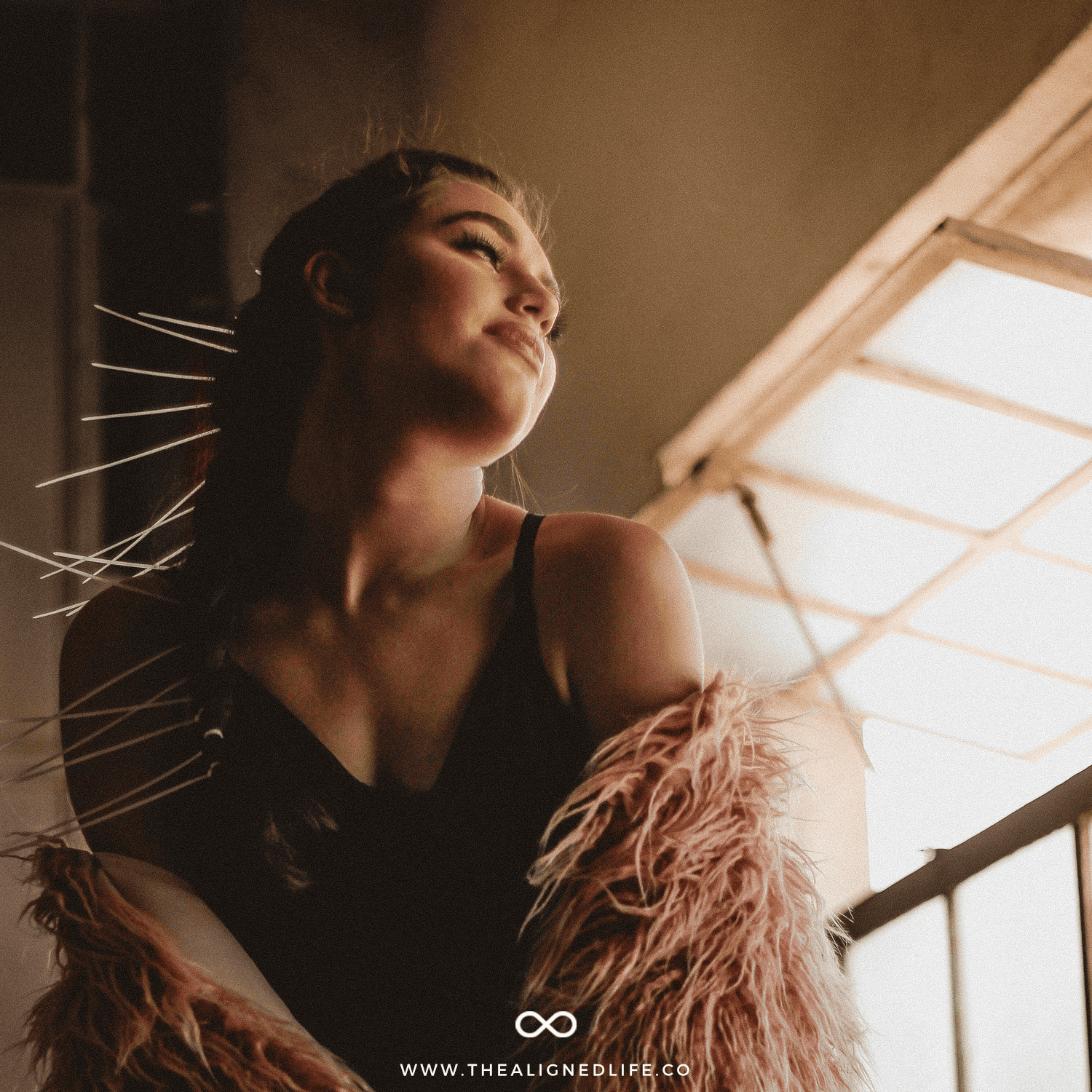 woman in a furry coat next to a railing | 5 Things You Cannot Manifest | The Aligned Life Manifestation Blog
