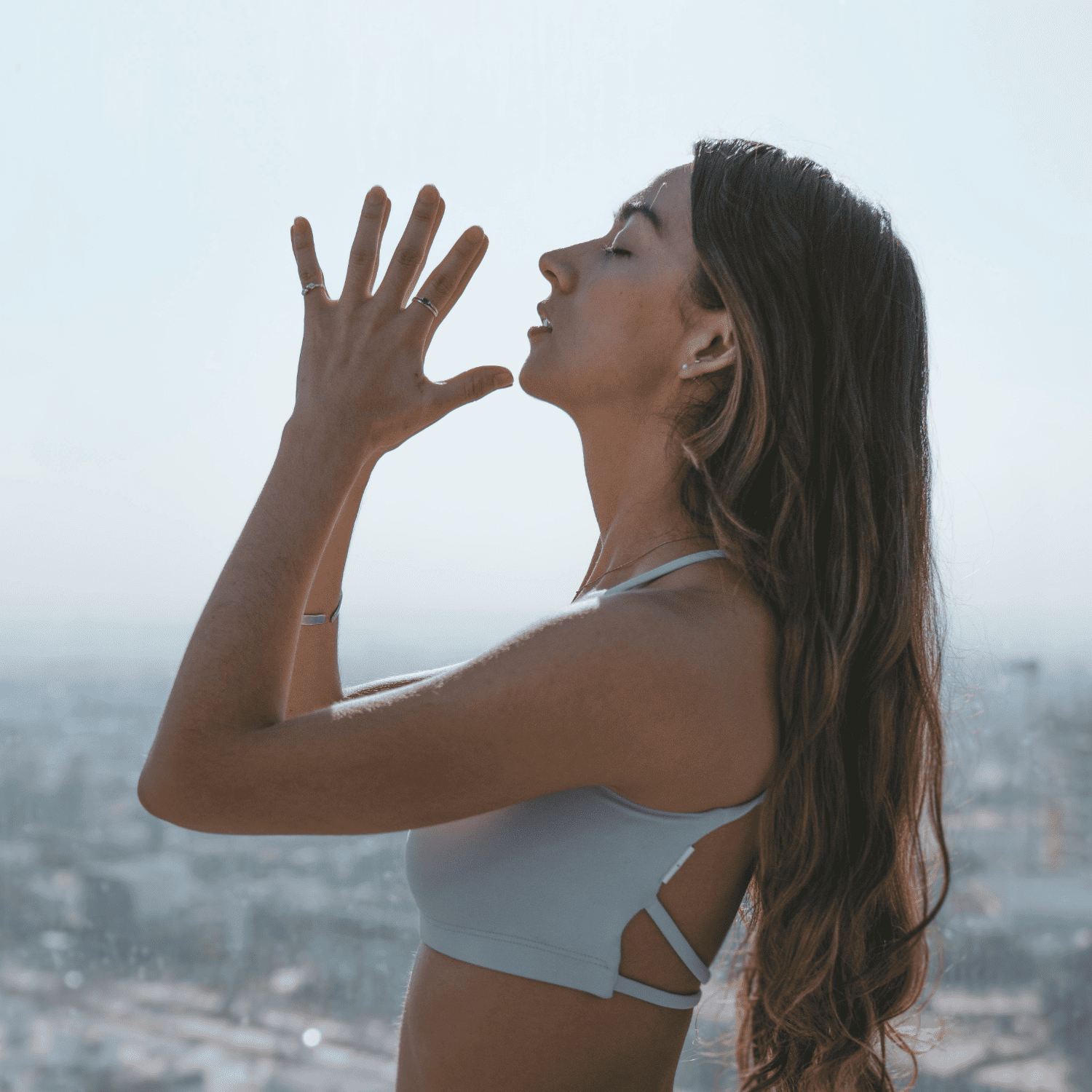 woman doing yoga on the beach | Guide to EFT Tapping | The Aligned Life Manifestation Blog
