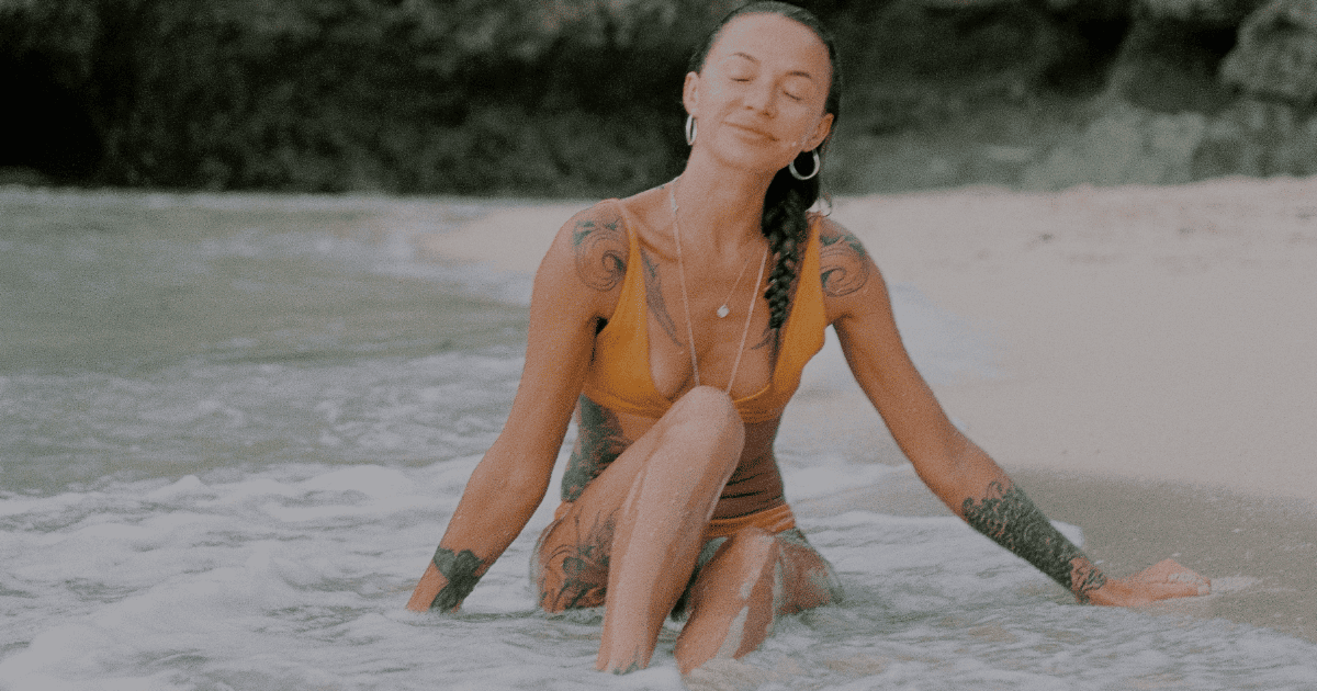 woman with her eyes closed at the beach | Emotional Healing Guide | The Aligned Life Blog