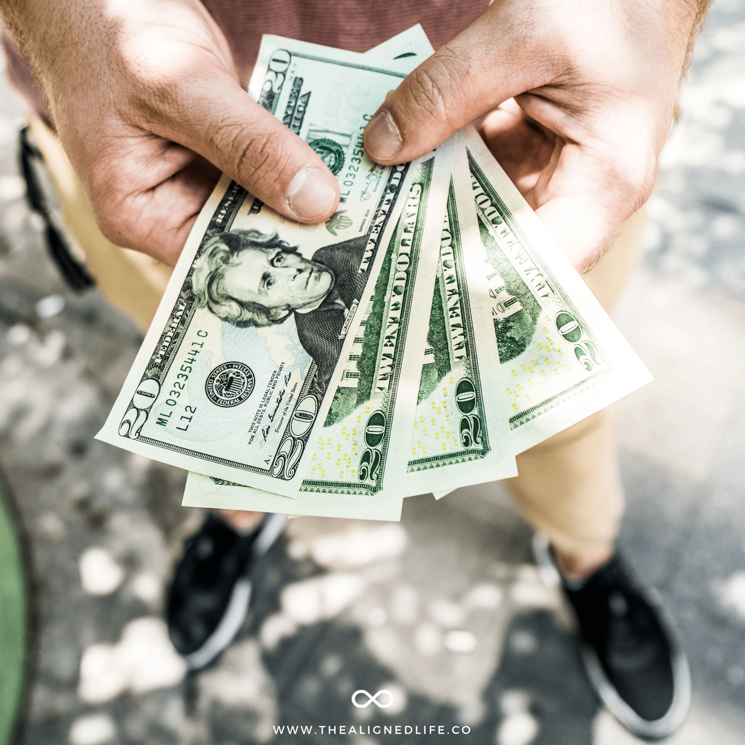 hands holding some $20 bills | 6 Keys To Manifest Money FAST! | The Aligned Life Manifestation Blog