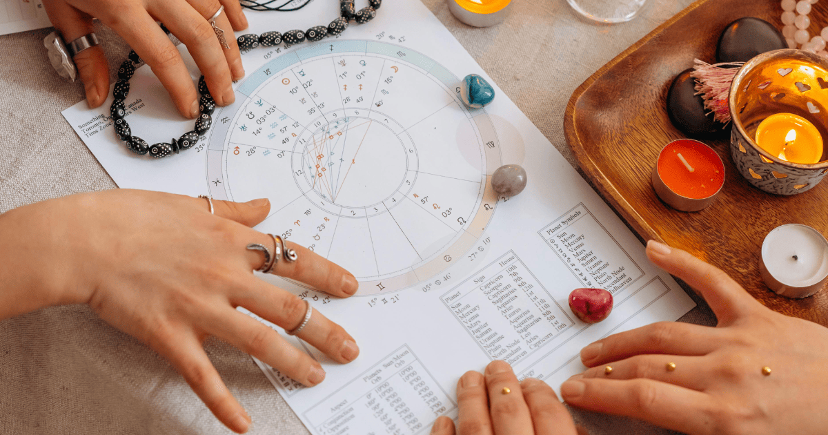 hands on an astrology birthchart with crystals | 3 Astrology Prompts for ChatGPT | The Aligned Life Manifestation + Spirituality Blog