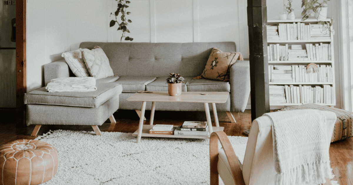 white living room with grey sofa | How To Manifest Anything Using Your Home | The Aligned Life Manifestation Blog