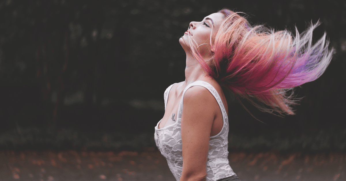 woman with pink hair in a white tank top | How To Become Unfuckwithable | The Aligned Life Manifestation Blog