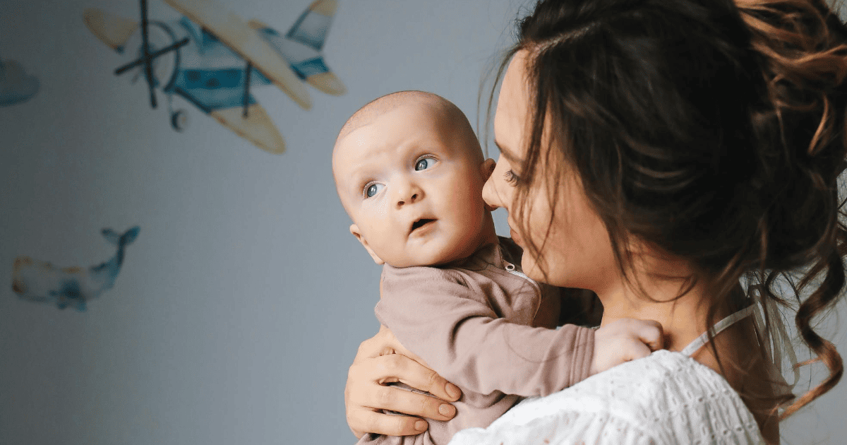woman holding a baby | How To Communicate With Your Spirit Baby | The Aligned Life Manifestation Blog