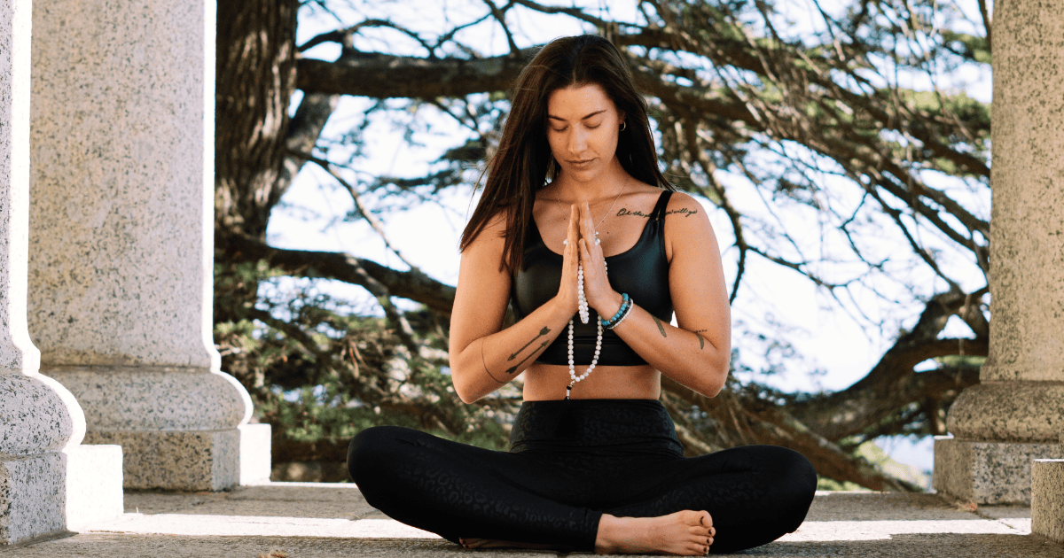 brunette woman with prayer beads in yoga pose & text How To Get Into Alignment