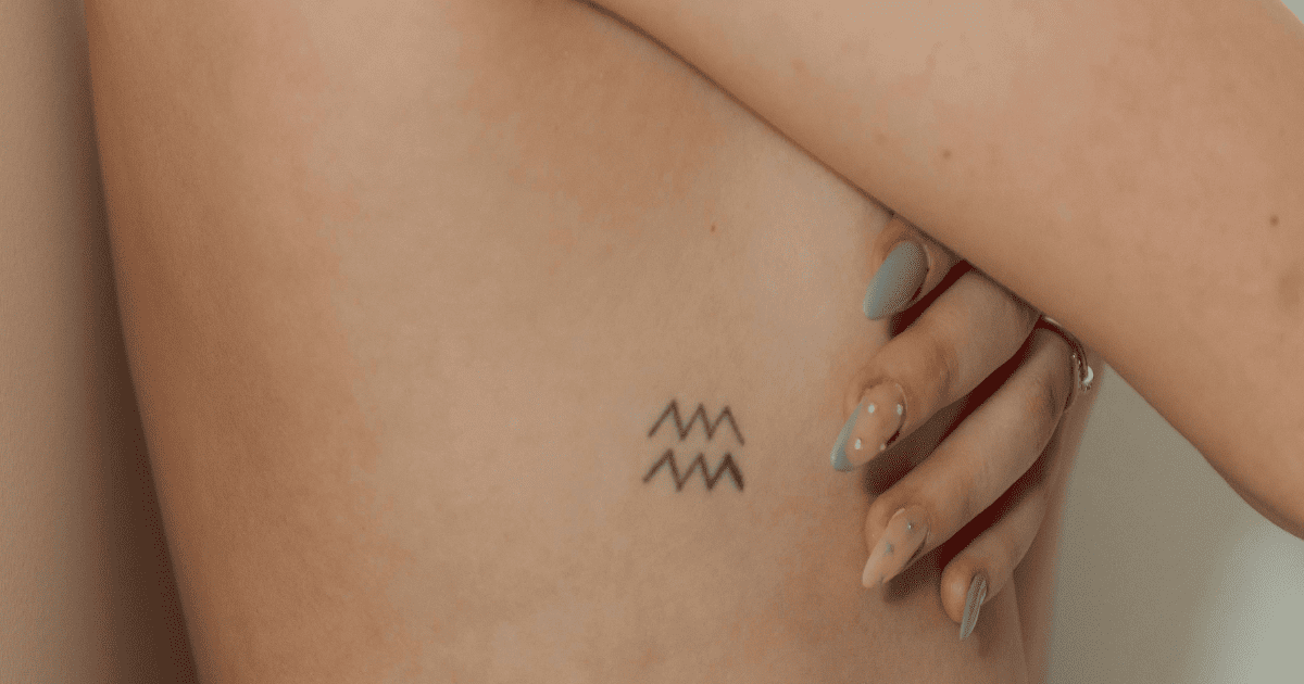 woman's ribcage with the symbol for Aquarius | Aquarius Season Report: Journal Prompts, Ritual Ideas & More