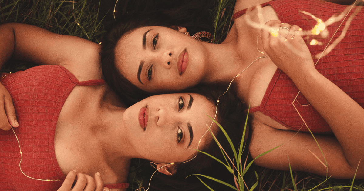 twins with dark hair lying in grass | Gemini Season: Journal Prompts, Ritual Ideas, Horoscopes & More! | The Aligned Life Manifestation & Spirituality Blog