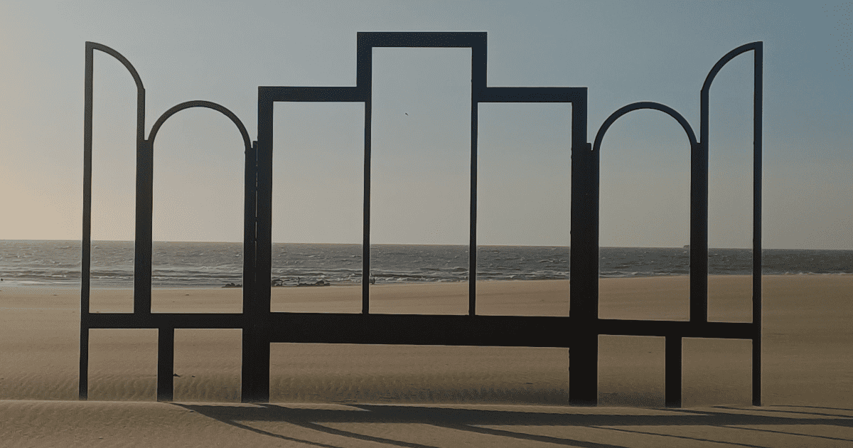 a black metal screen with windows on a beach
